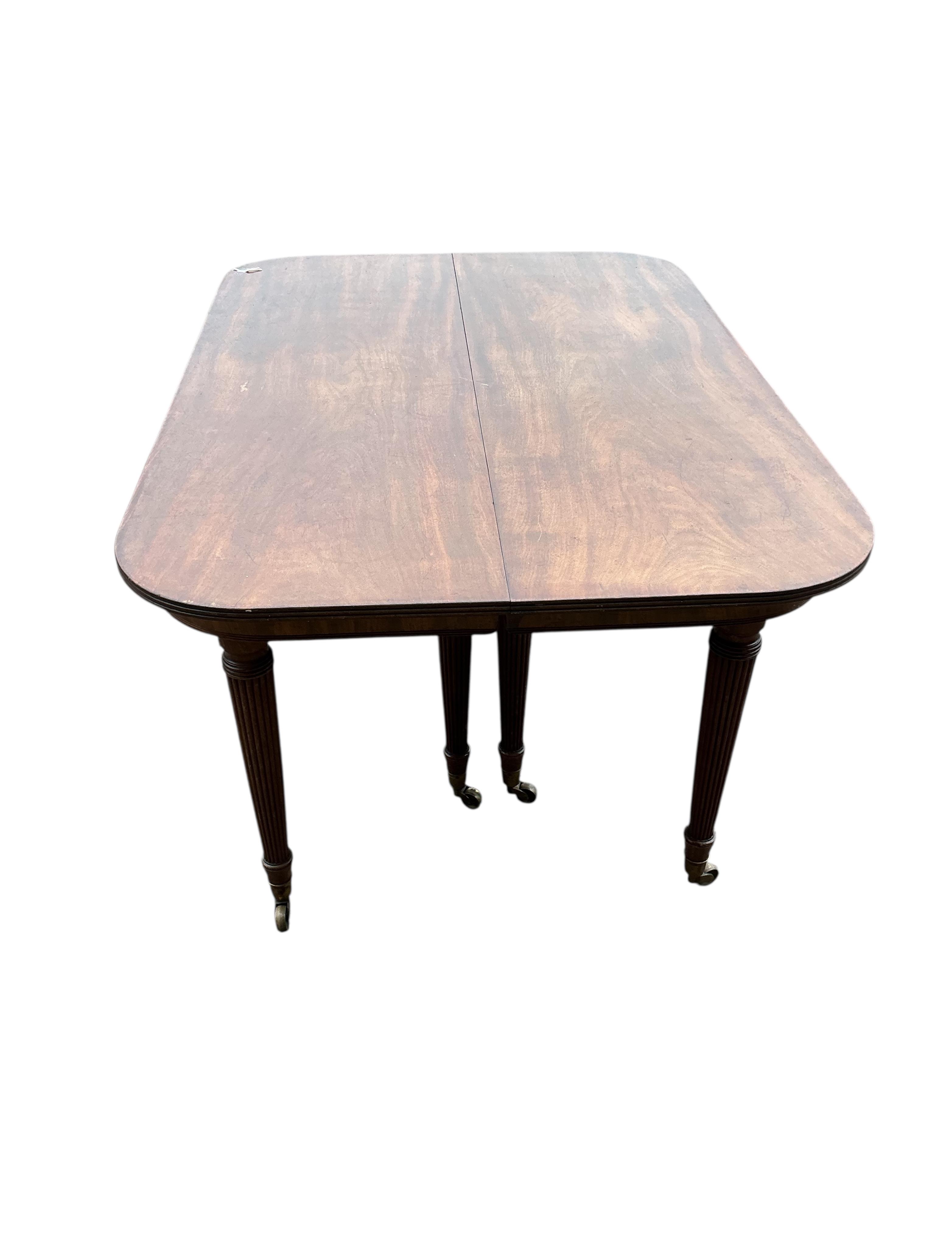 A Regency mahogany extending dining table, width 180cm extended, two spare leaves, depth 140cm, height 74cm